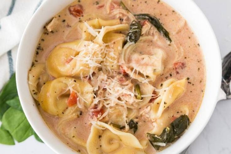 white bowl of tortellini soup