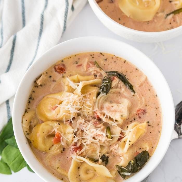 tortellini soup  in bowls on a table 