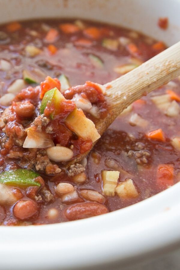 olive garden minestrone soup in slow cooker with wooden spoon
