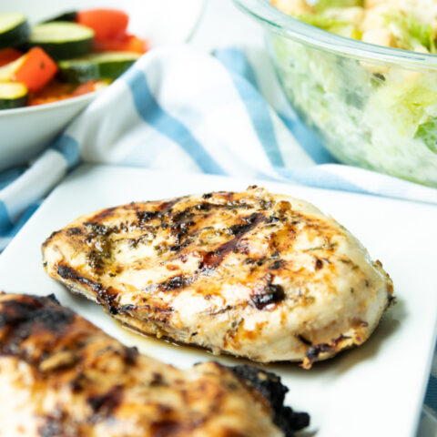 lemon garlic chicken on a plate with salad
