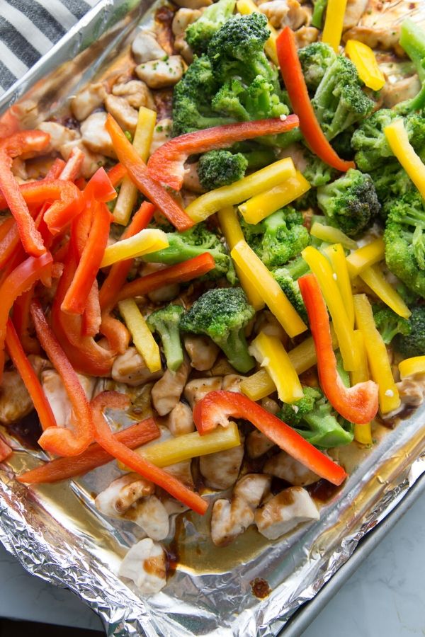 chicken sheet pan topped with vegetables