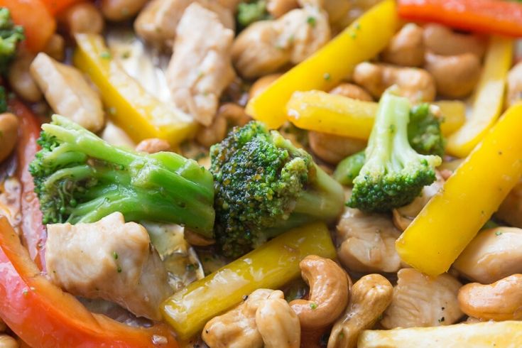 cashew chicken with vegetables on a sheet pan