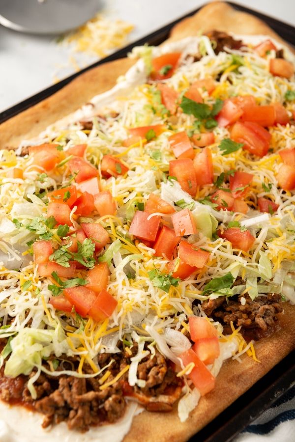 pan with taco pizza on it with all the toppings