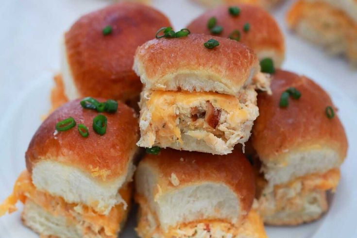 hawaiian roll sliders stacked on a plate