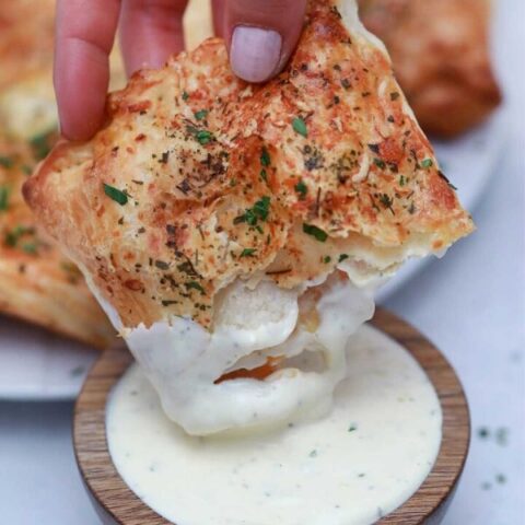 dipping ham pocket in ranch dressing bowl
