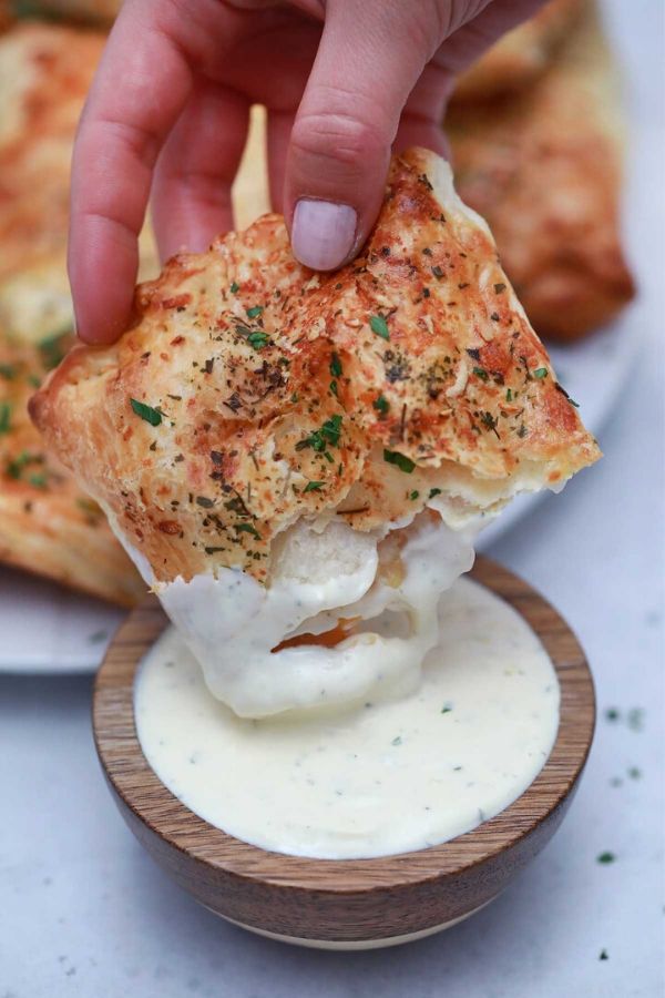 dipping ham pocket in ranch dressing bowl