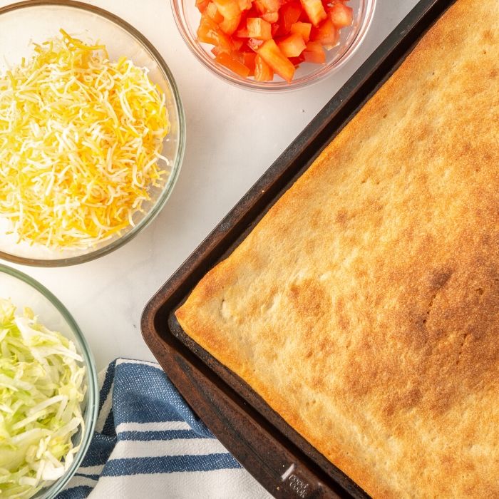 pizza taco pizza dough and topping ingredients by it 