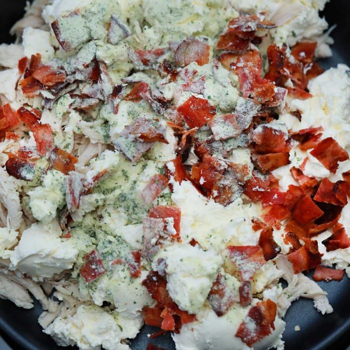 crack chicken ingredients in a pan on stove 