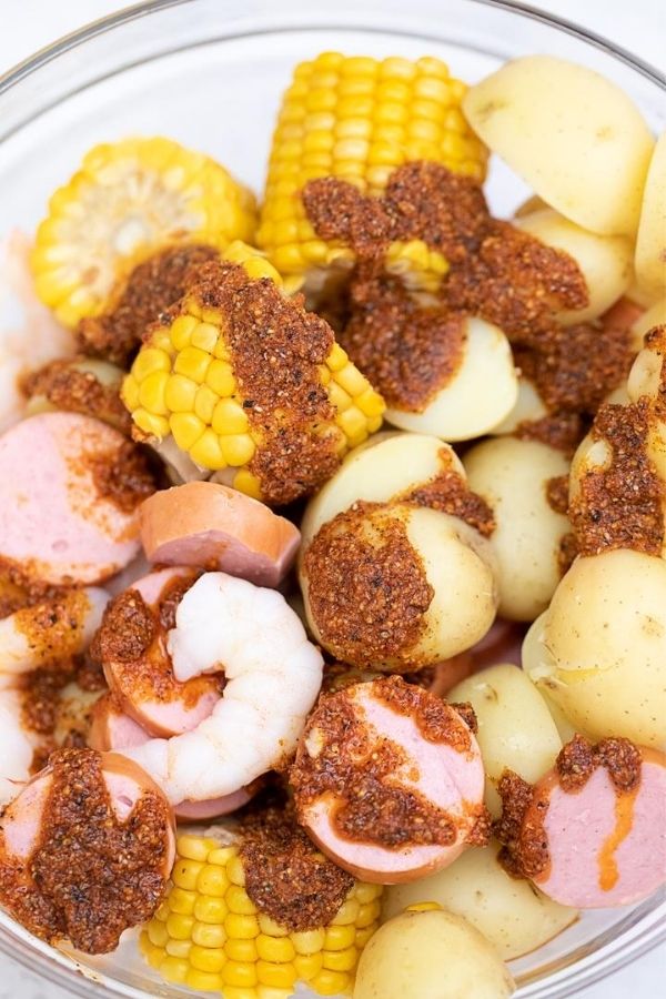 seafood ingredients in a bowl with seasoning on top