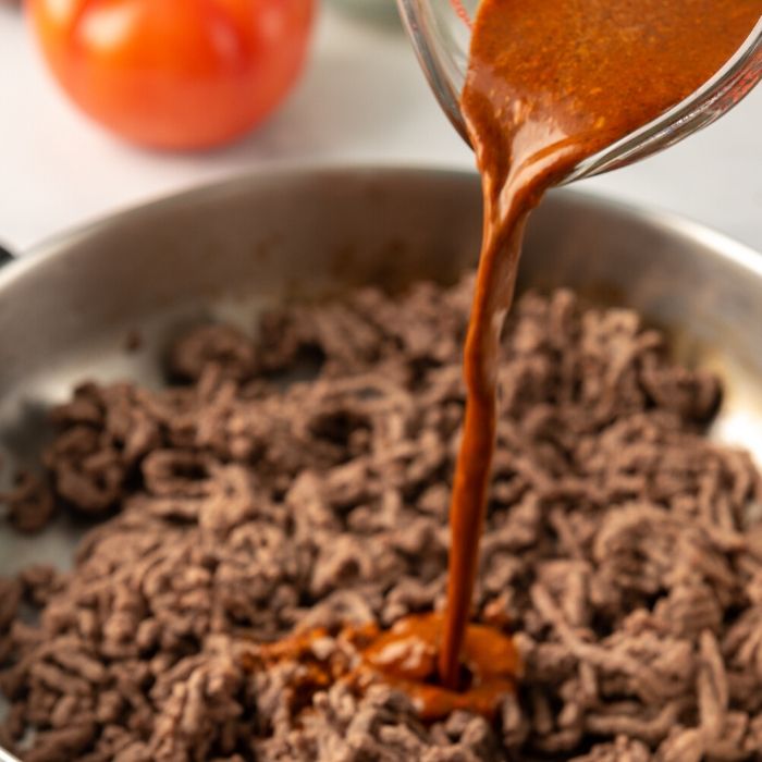 ground beef with taco seasoning getting poured in