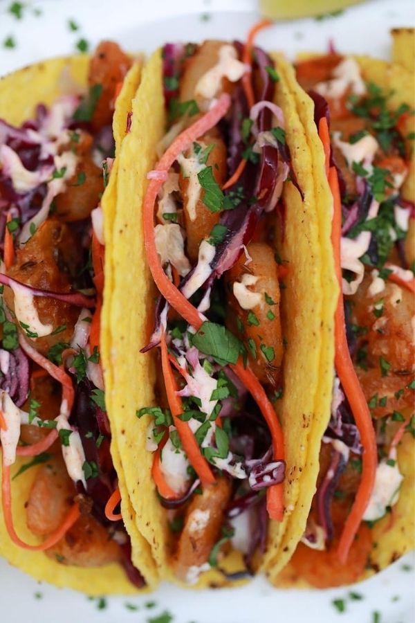 shrimp tacos in corn shells on plate