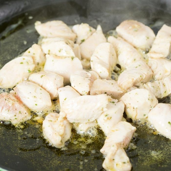 boneless chicken cooking in a skillet