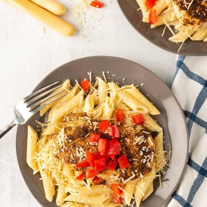 creamy chicken pasta on a brown plate