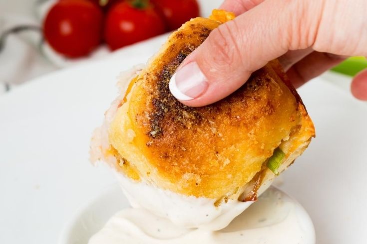turkey sandwich being dipped in ranch