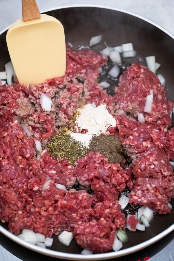 ground beef and skillet with seasonings 