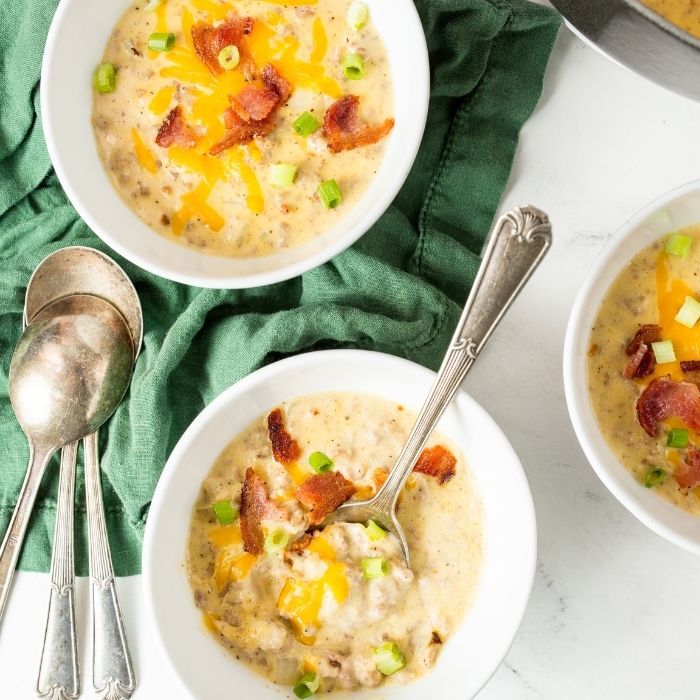 bowls of soup with spoons by it on table 