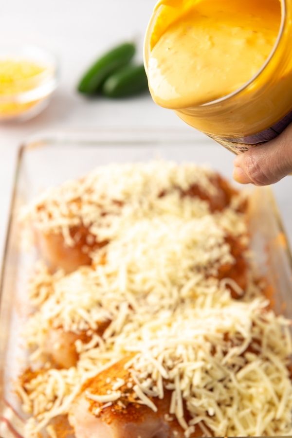chicken con queso pouring over chicken