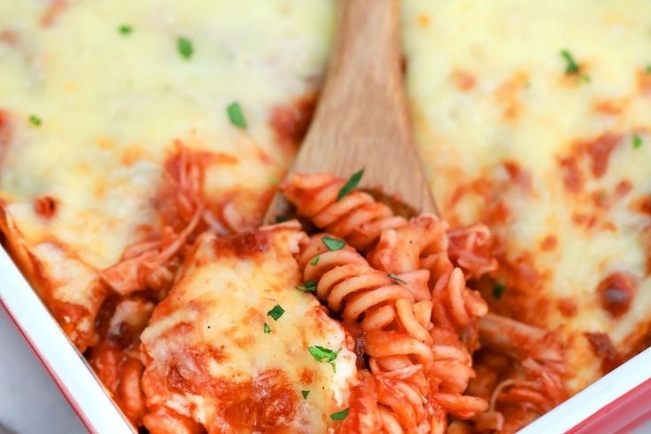 chicken pasta with spoon in casserole dish