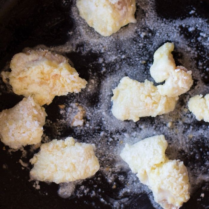 chicken frying in skillet 