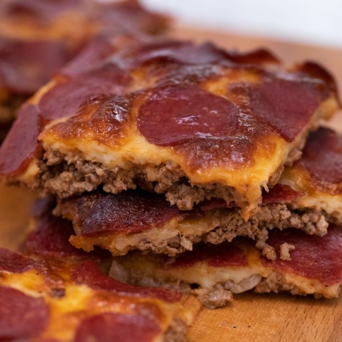 stacked crustless pizza on a cutting board
