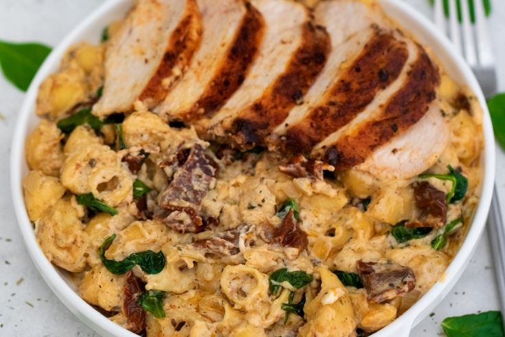tuscan macaroni and cheese in a bowl with chicken