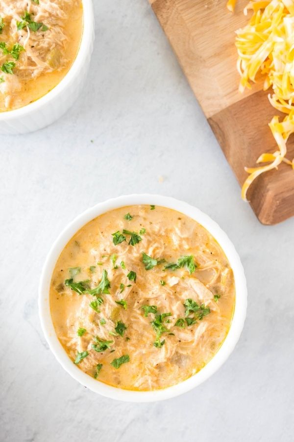 bowl of chicken chili soup with wooden bar