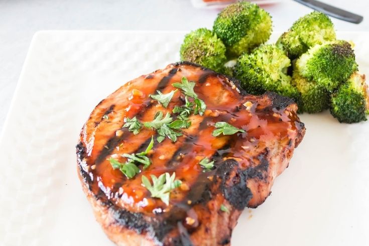 pork chop plated with broccoli