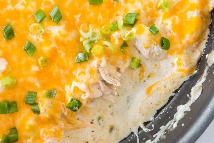 sour cream chicken in a skillet with some scooped out