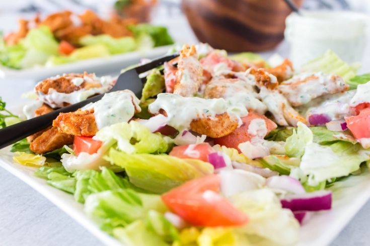 taco tossed salad with dressing on a plate