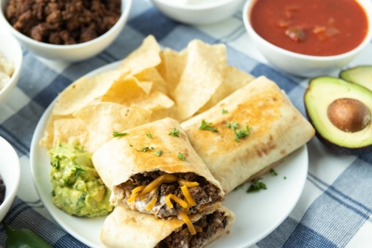 easy grilled burritos on plate with topping ideas all around it