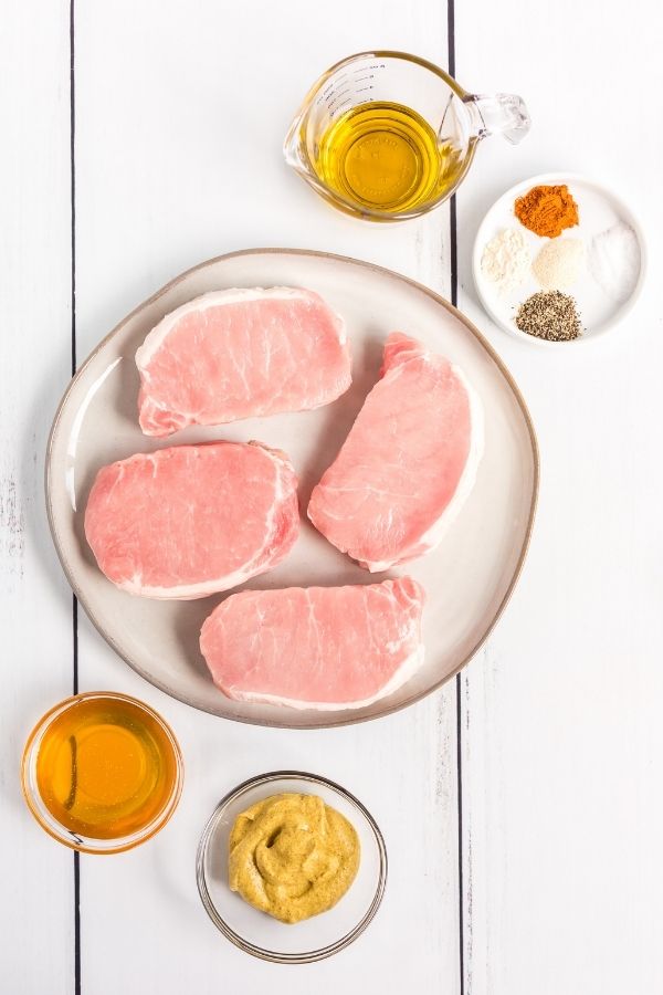 ingredients for grilled pork chops on a table