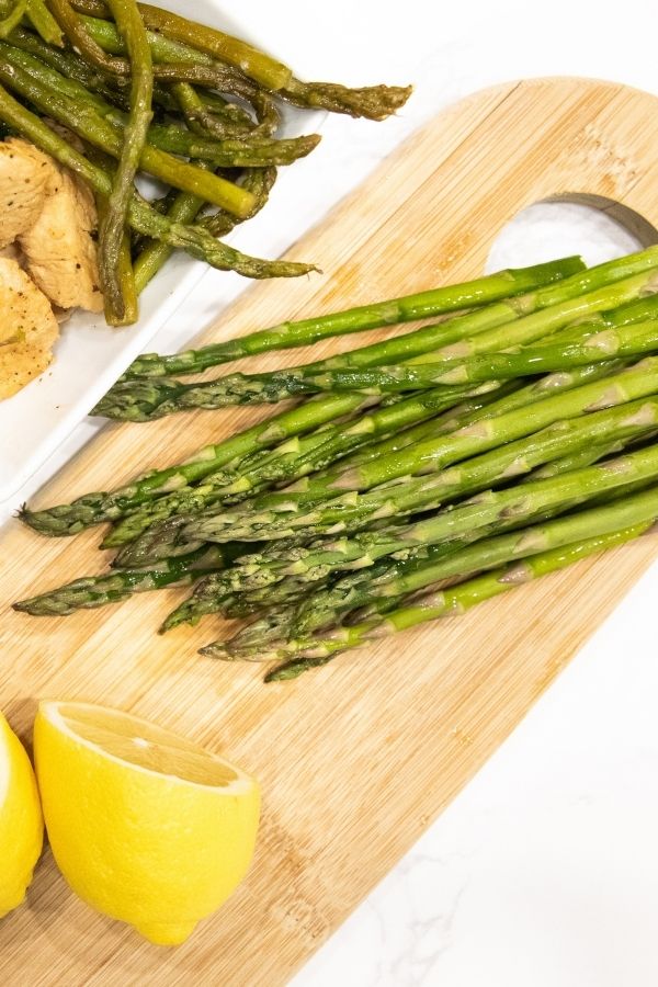 asparagus and lemon on cutting board 