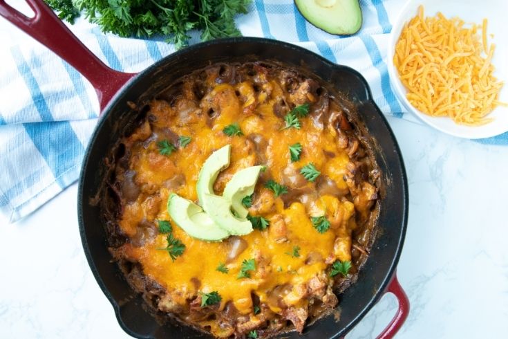 fajita skillet topped with avocados