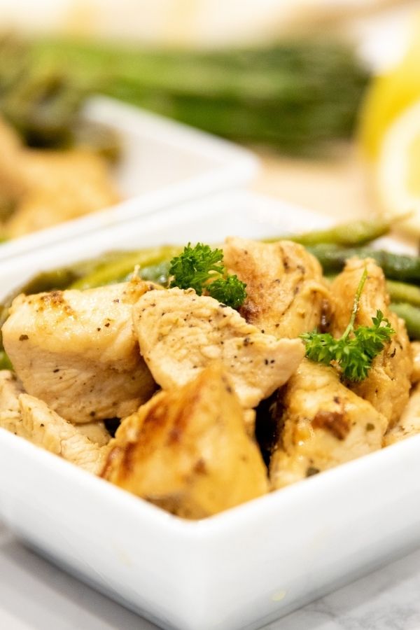 square bowl with chicken and asparagus