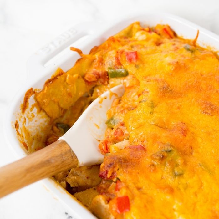 wooden spoon in a casserole dish with mexican chicken