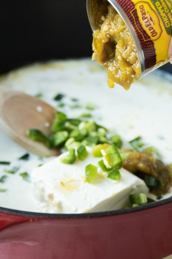 cream cheese and green chilis in pan with other ingredients 