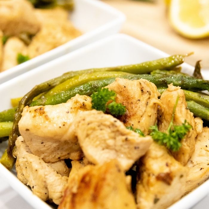 close up picture of chicken and asparagus in a bowl