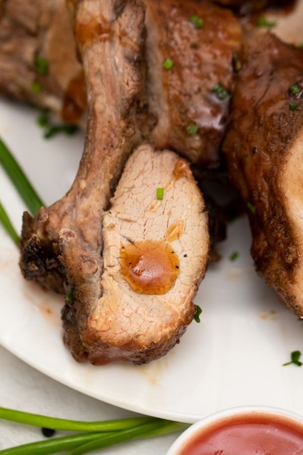 tender rib with sauce on a plate with dip by it 