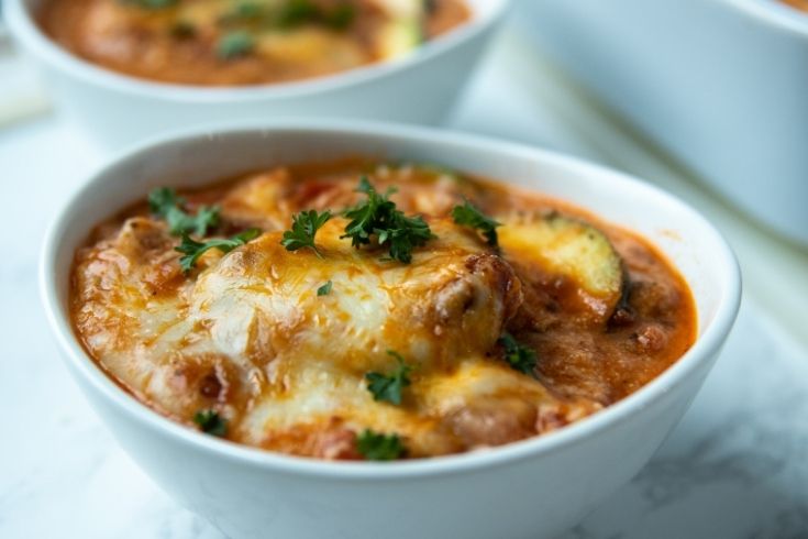 zucchini lasagna in a bowl topped with parsley