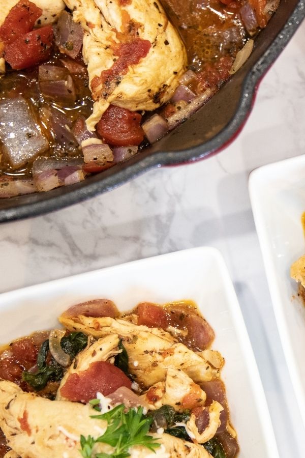 chicken and tomato dish in skillet and square bowl