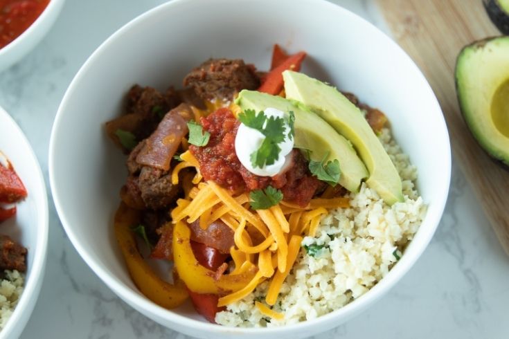 steak fajita bowl topped with tons of toppings